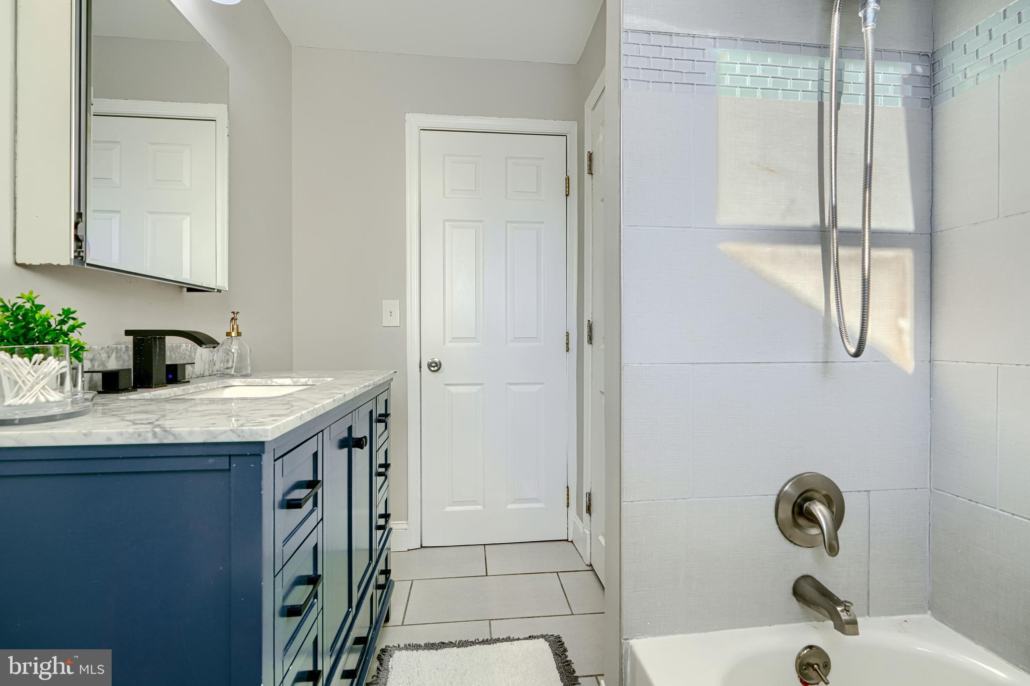1203 Hilldale Road Baltimore, MD 21237 - Photo 24 of 55 a bathroom with a granite countertop sink a toilet and shower