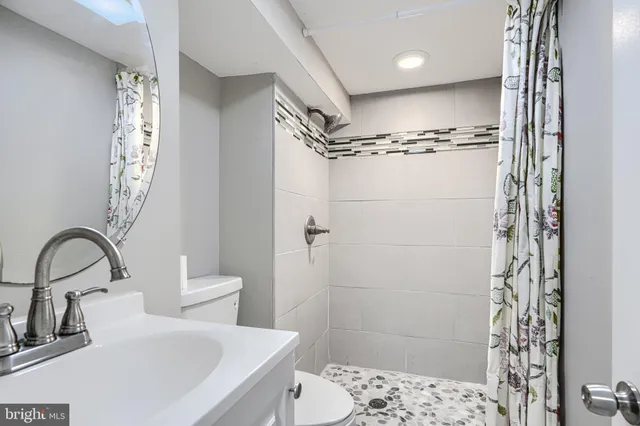 a bathroom with a sink toilet and shower