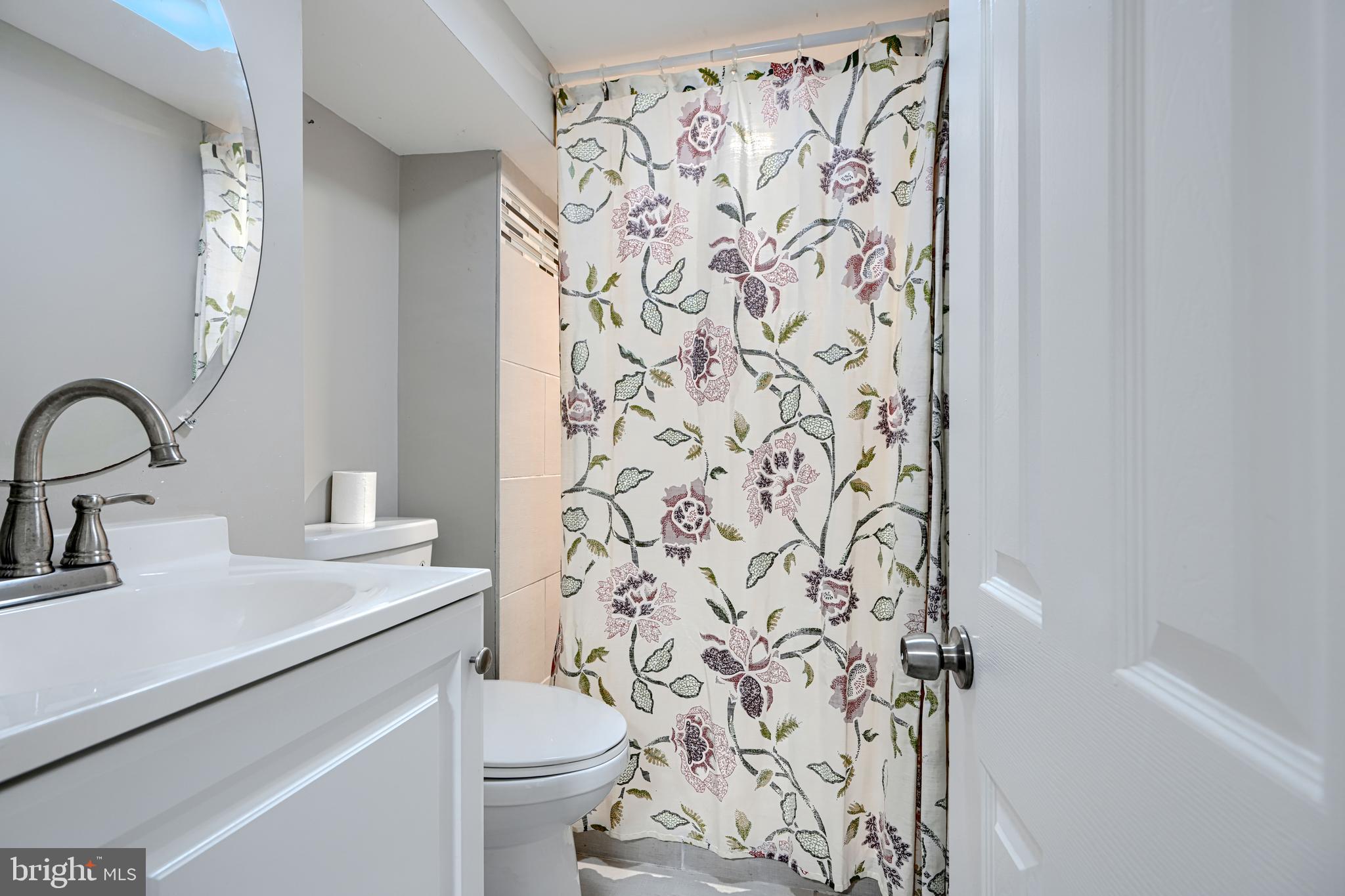 1203 Hilldale Road Baltimore, MD 21237 - Photo 41 of 55 a bathroom with a sink toilet and a mirror