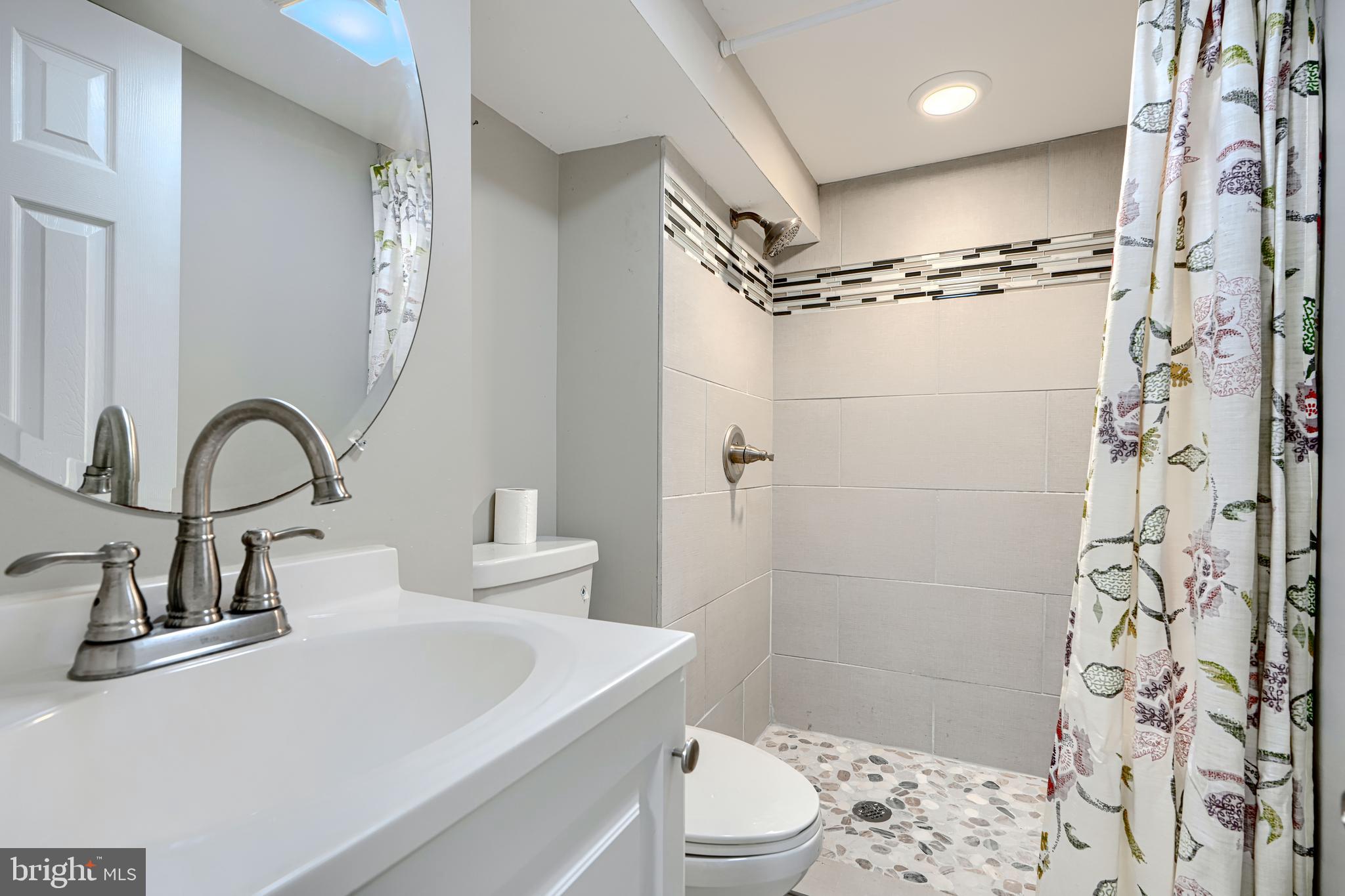 1203 Hilldale Road Baltimore, MD 21237 - Photo 42 of 55 a bathroom with a sink toilet and shower