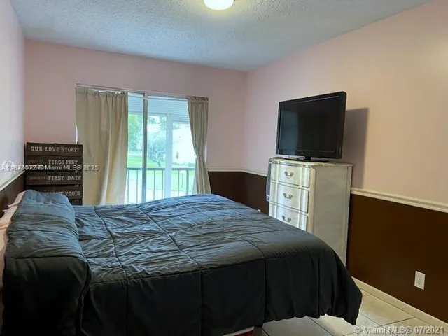 a bedroom with a bed and a television