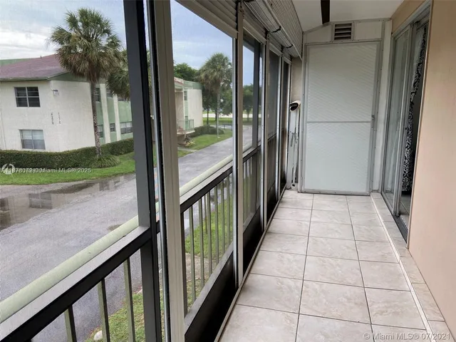 a view of a balcony with wooden floor