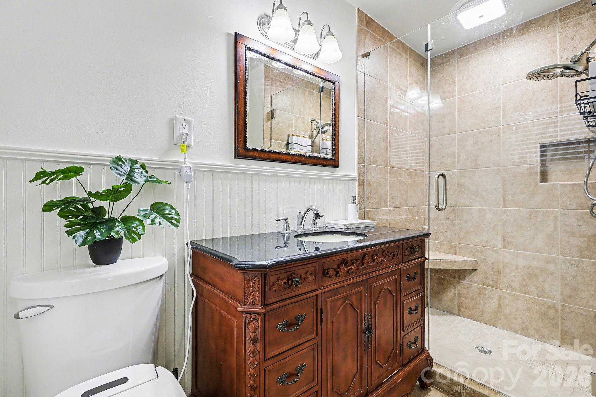 123 Old Bell Road Charlotte, NC 28270 - Photo 19 of 46 a bathroom with a granite countertop sink a toilet a mirror and shower