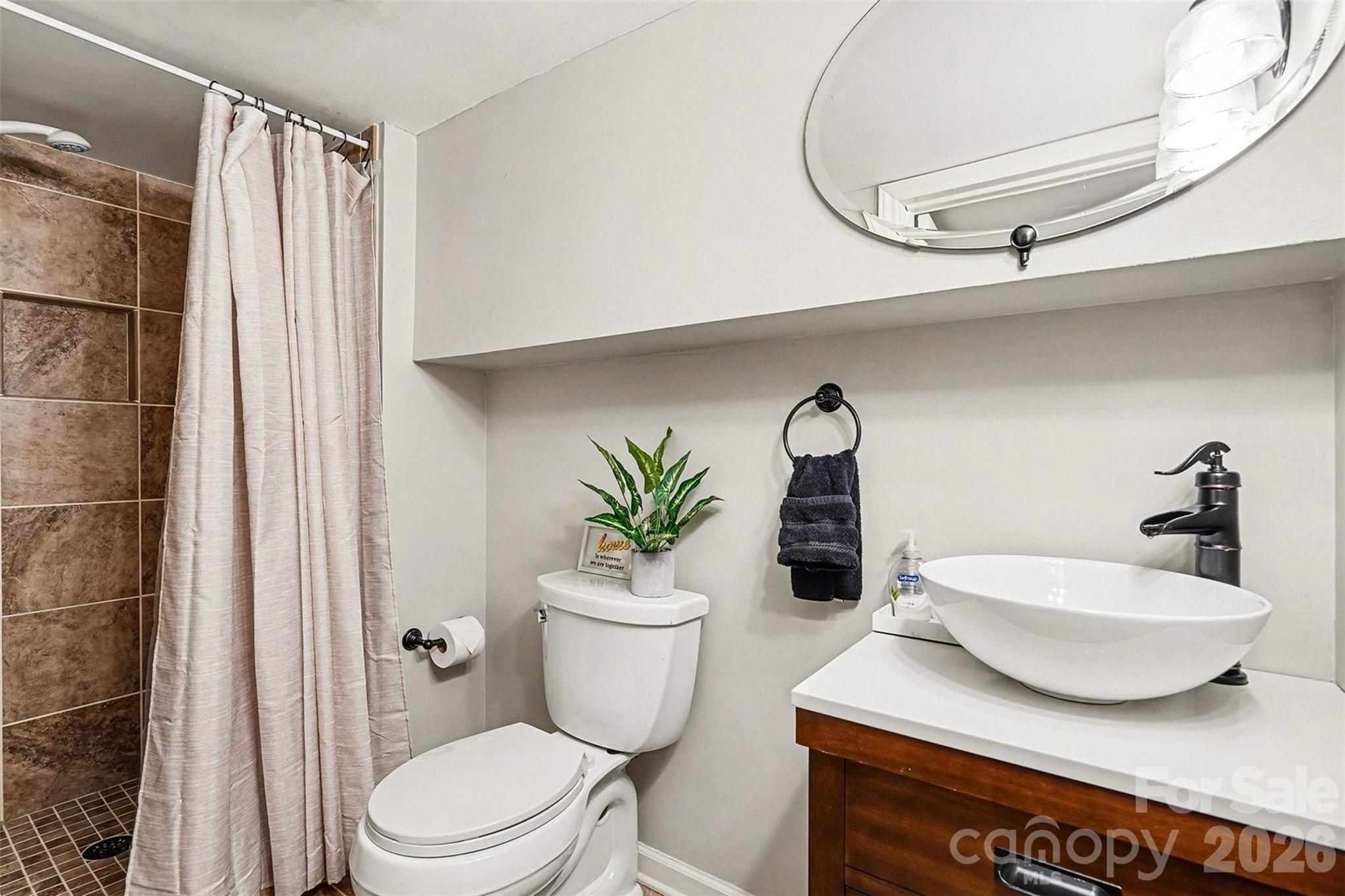123 Old Bell Road Charlotte, NC 28270 - Photo 32 of 46 a bathroom with a sink a toilet and a mirror