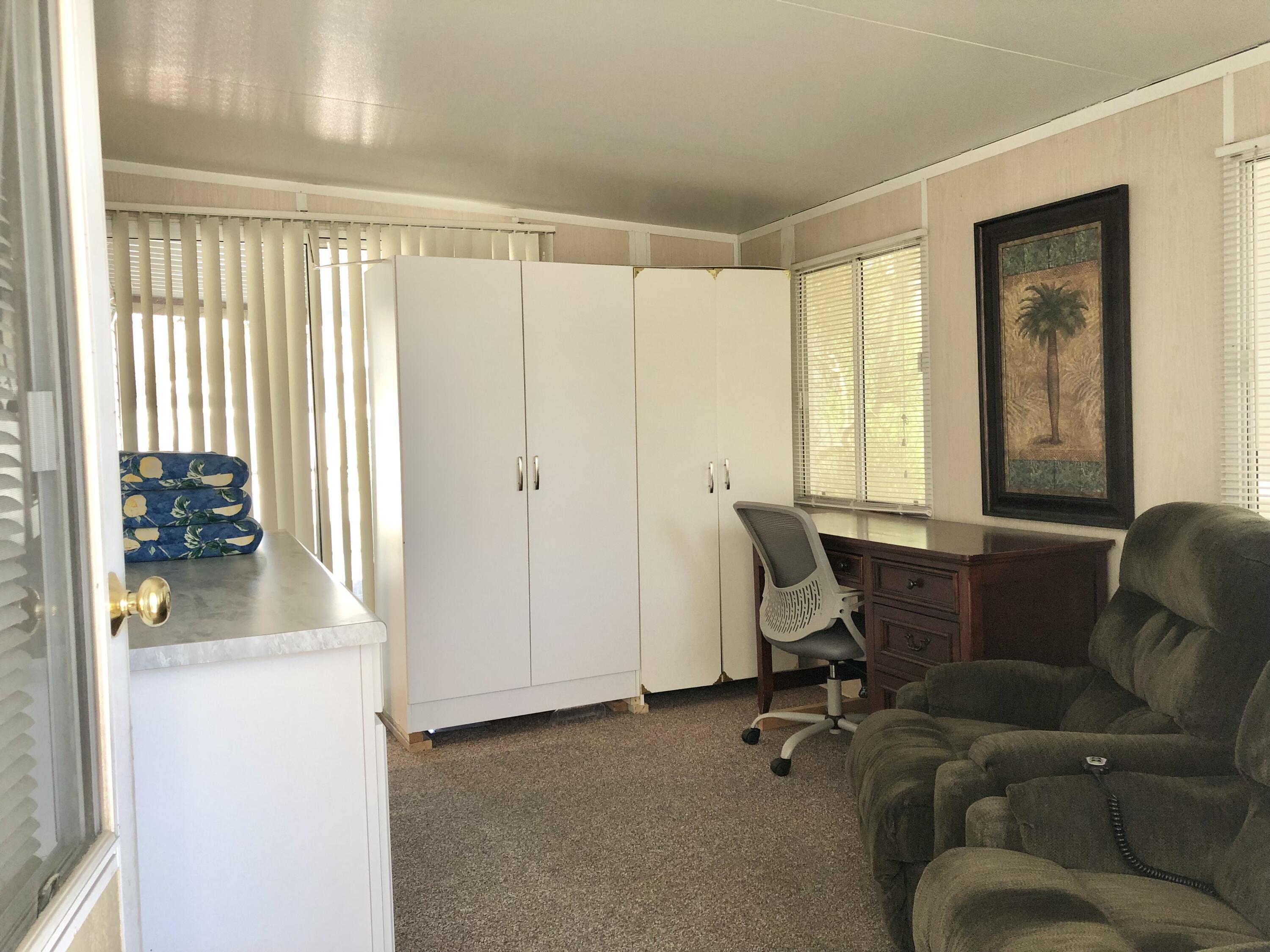 74711 Dillon Road Desert Hot Springs, CA 92241 - Photo 12 of 44 a living room with furniture and a window