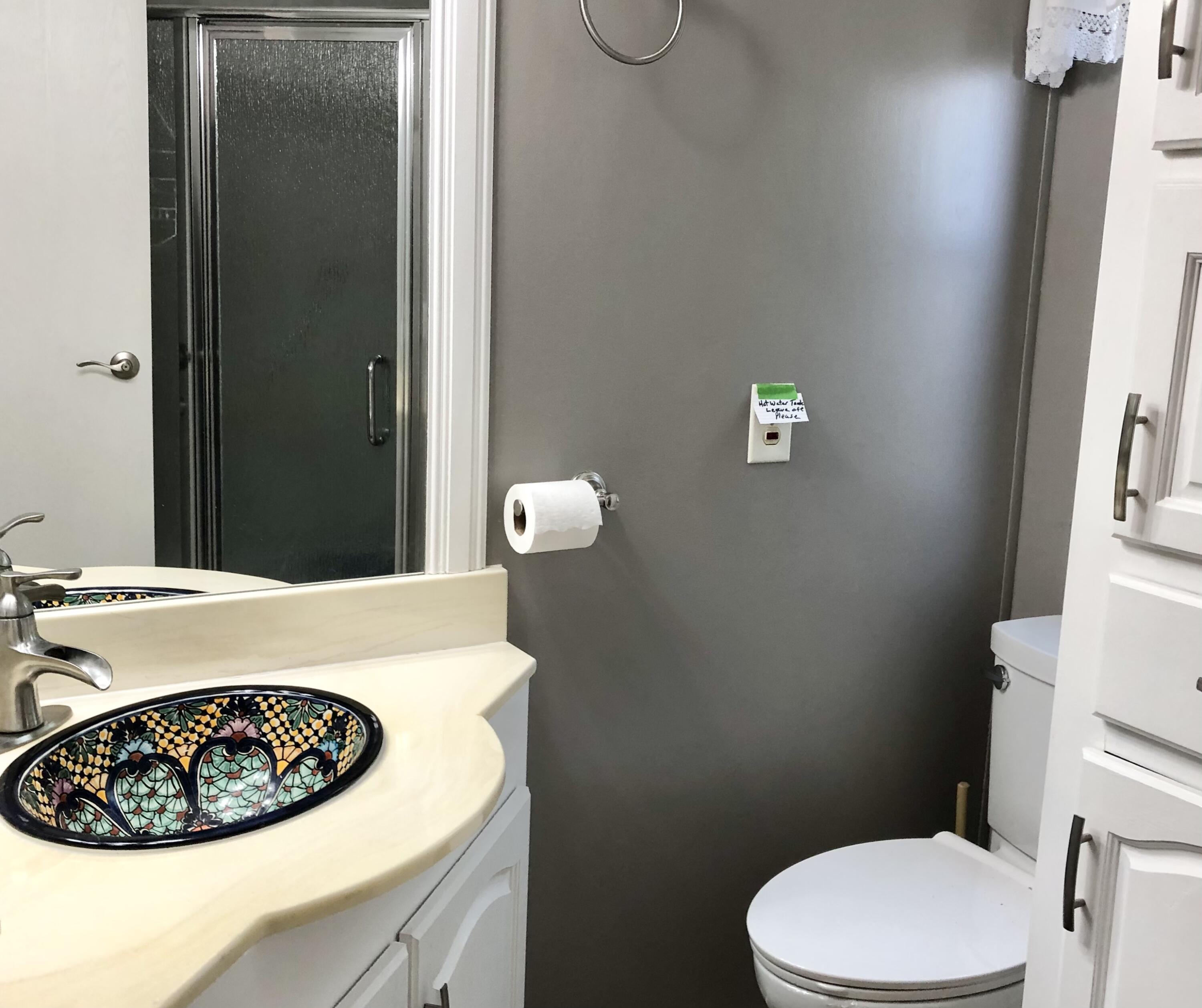 74711 Dillon Road Desert Hot Springs, CA 92241 - Photo 16 of 44 a bathroom with a sink a toilet and vanity