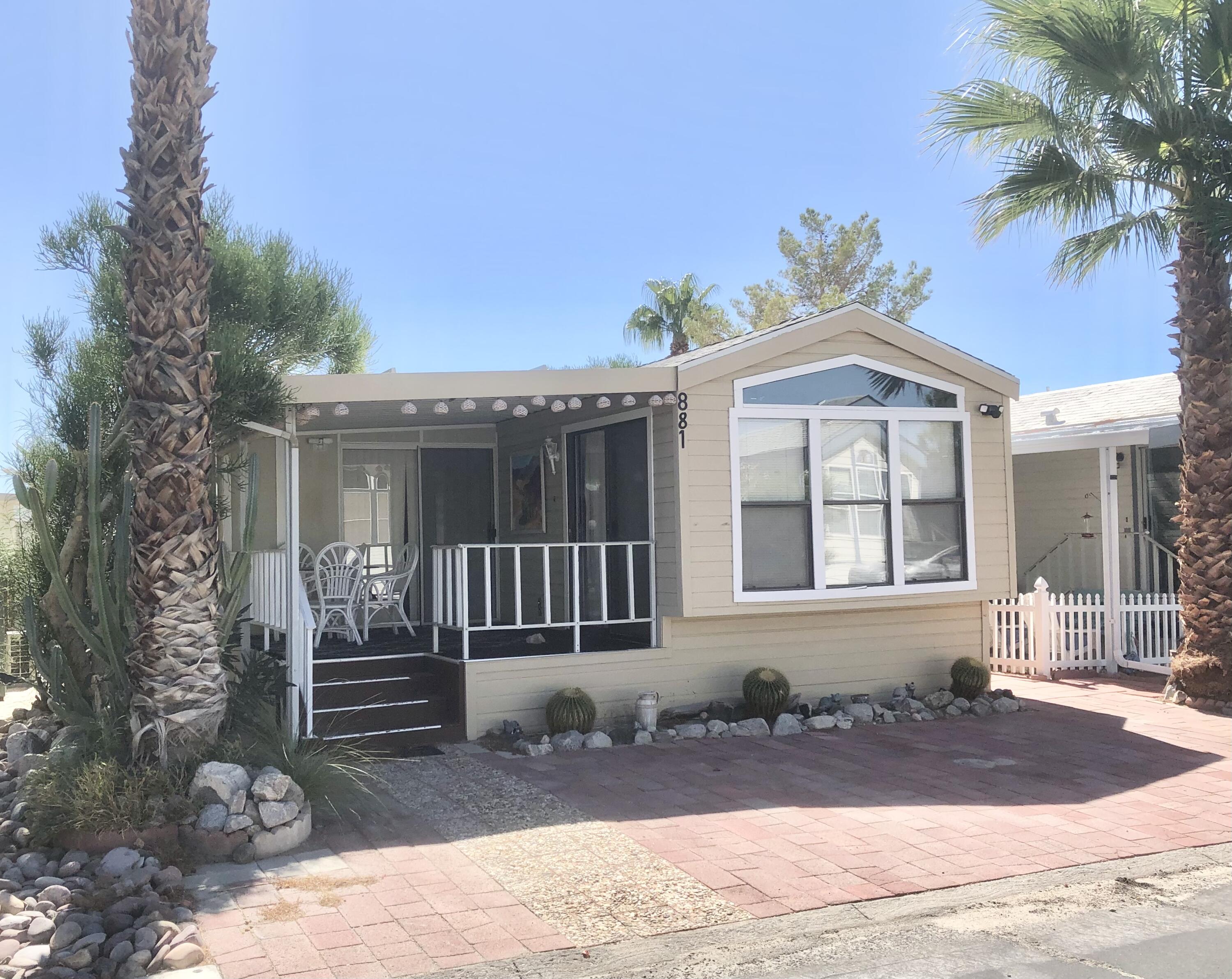 74711 Dillon Road Desert Hot Springs, CA 92241 - Photo 2 of 44 a front view of a house with a yard