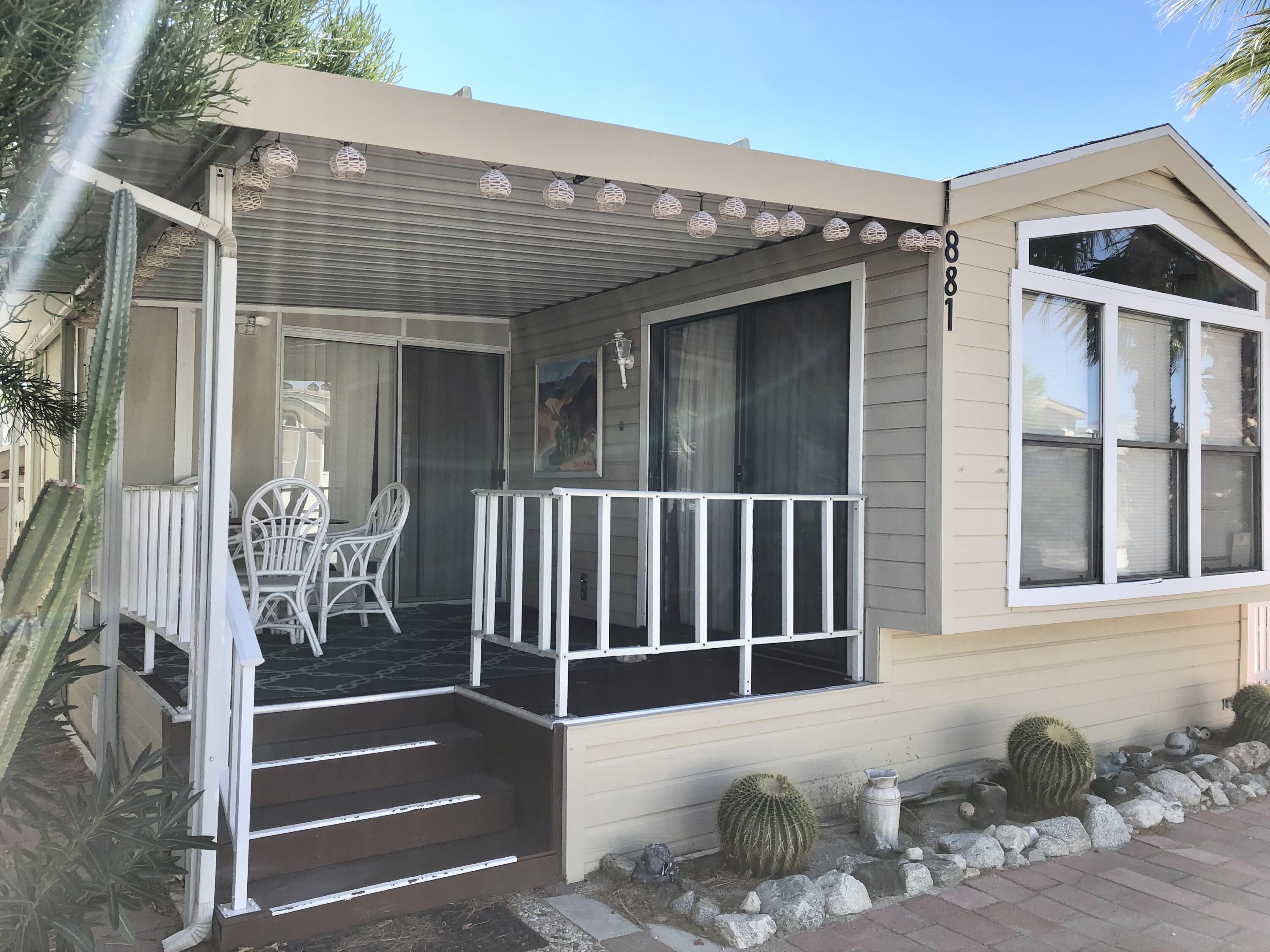 74711 Dillon Road Desert Hot Springs, CA 92241 - Photo 3 of 44 a view of a patio with table and chairs and potted plants