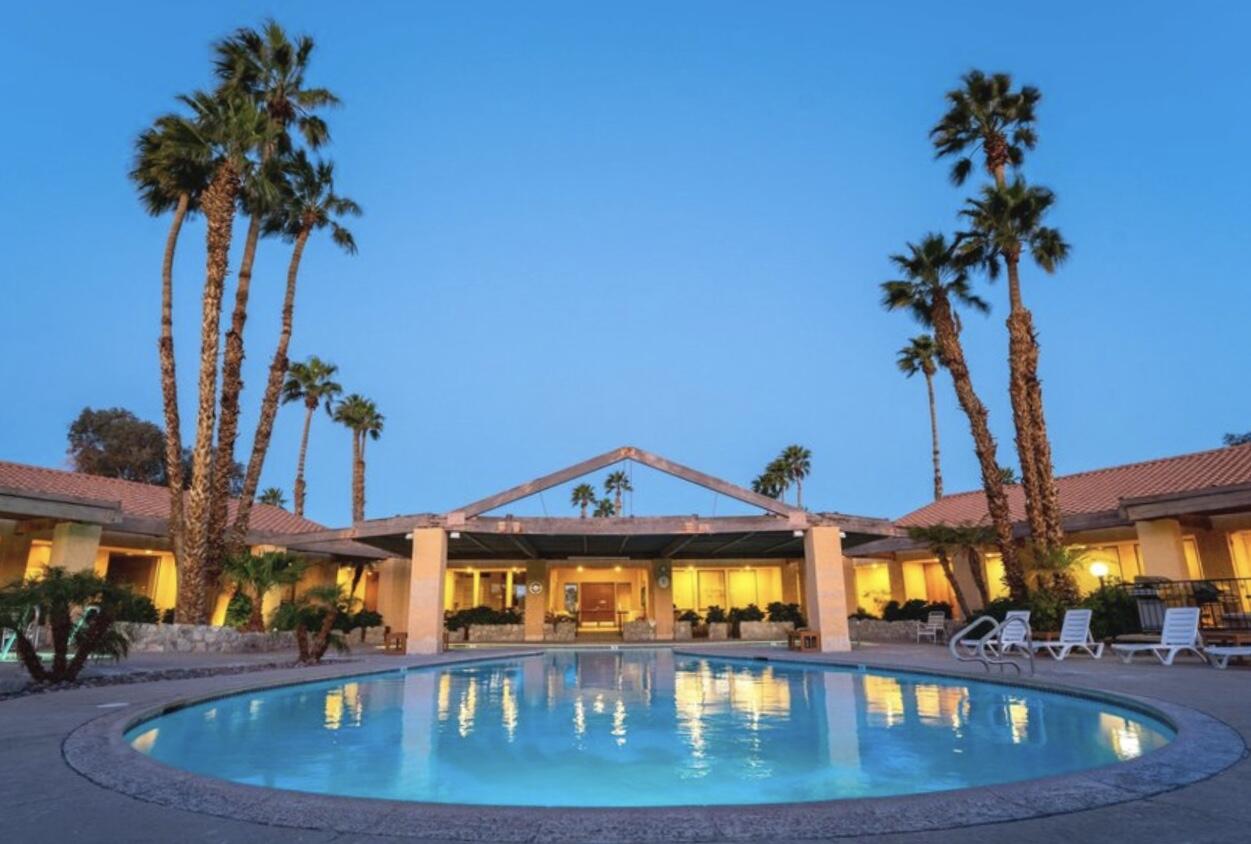 74711 Dillon Road Desert Hot Springs, CA 92241 - Photo 40 of 44 a view of a swimming pool with a table and chairs