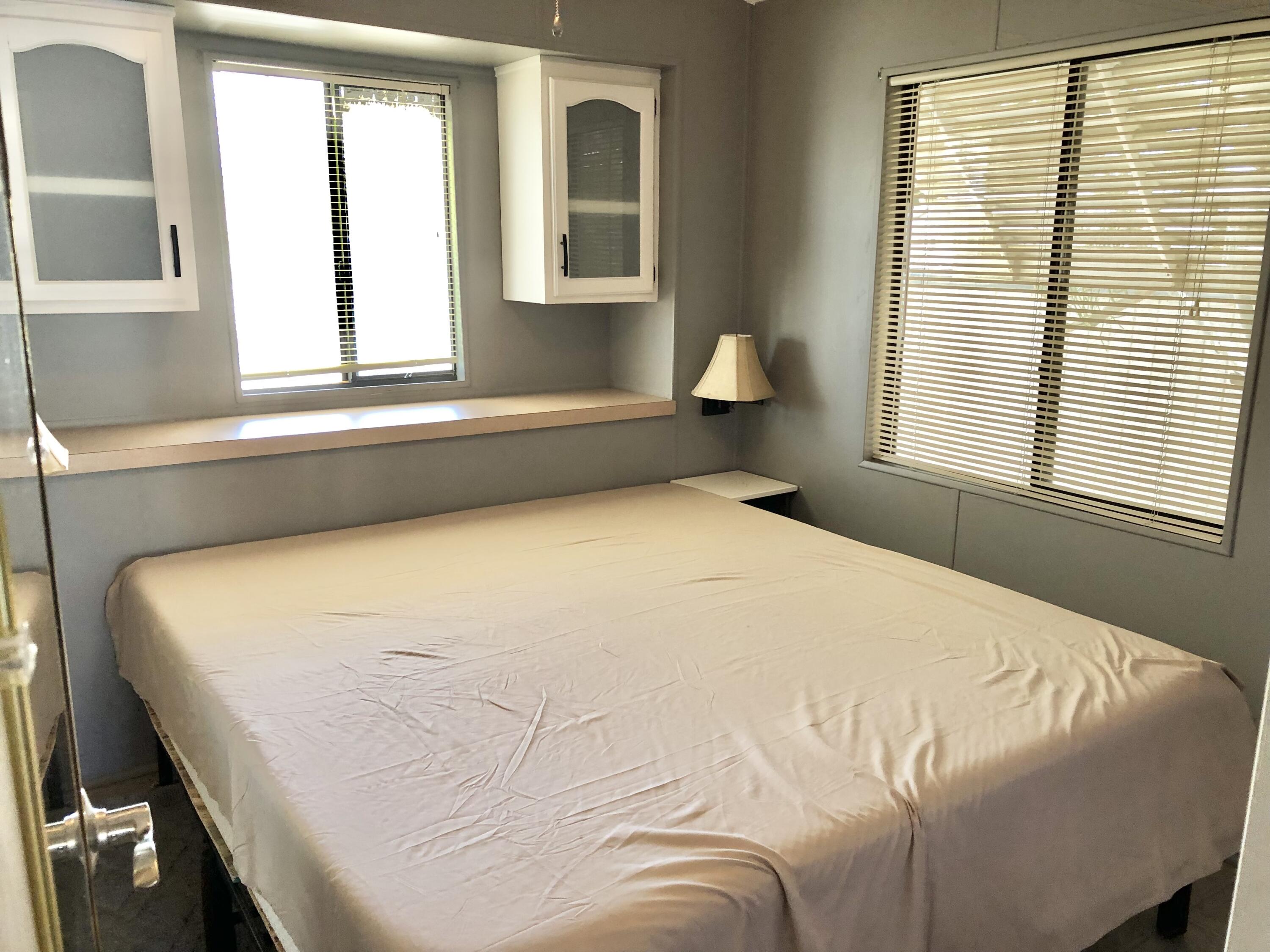 74711 Dillon Road Desert Hot Springs, CA 92241 - Photo 10 of 44 a bedroom with a bed and next to a window