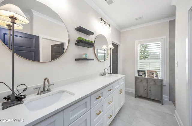 a bathroom with a double vanity sink and a mirror
