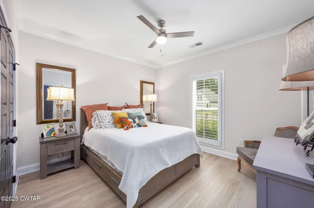 a bedroom with a bed and a desk