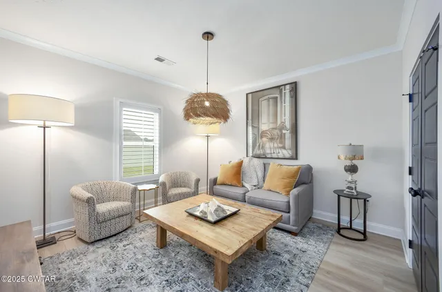 a living room with furniture a lamp and a window