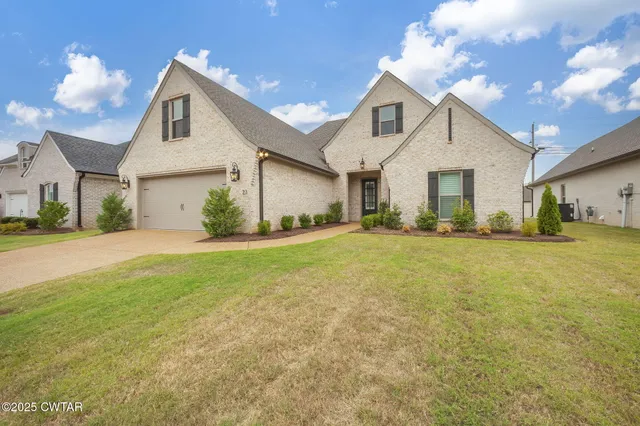 a front view of house with yard and green space