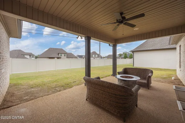 a view of swimming pool with a table and chairs under an umbrella