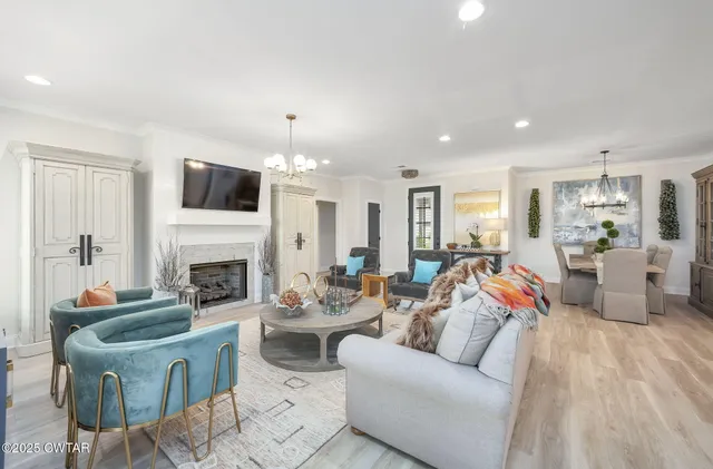 a living room with furniture fireplace and a flat screen tv