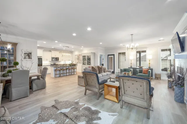 a living room with lots of furniture and view of kitchen