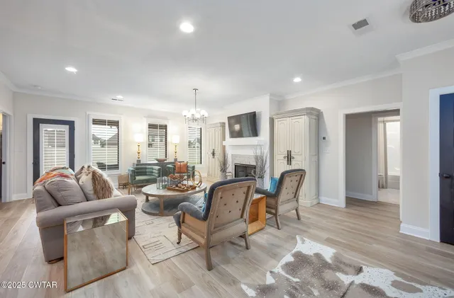 a living room with furniture a large window and a rug