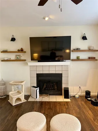 a living room with furniture a flat screen tv and a fireplace