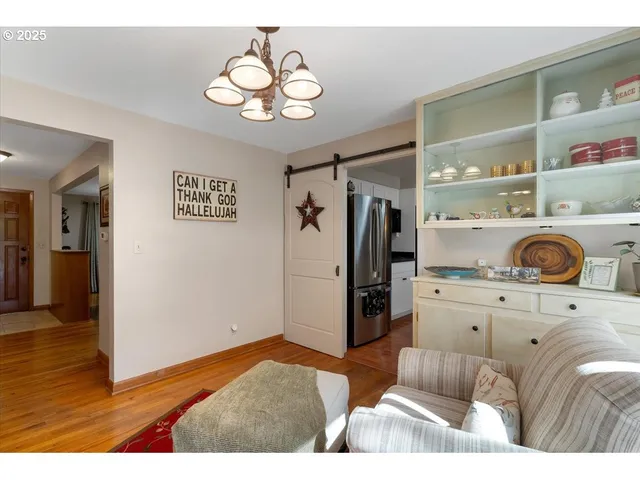 a view of kitchen with stainless steel appliances granite countertop cabinets and wooden floor