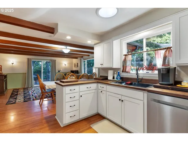 a kitchen with cabinets a sink and appliances