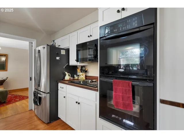 a kitchen with stainless steel appliances kitchen island granite countertop a refrigerator and a stove