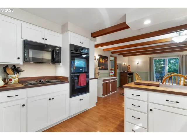 a kitchen with granite countertop a sink and stainless steel appliances