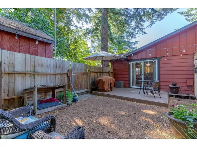 a view of a small house and a yard with a patio