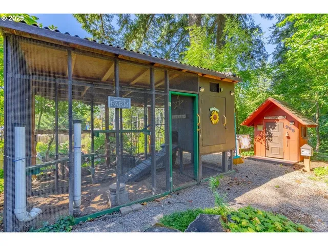 a view of a chair and table in backyard of the house