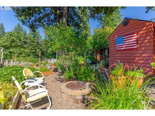 a view of a chairs and table in a backyard
