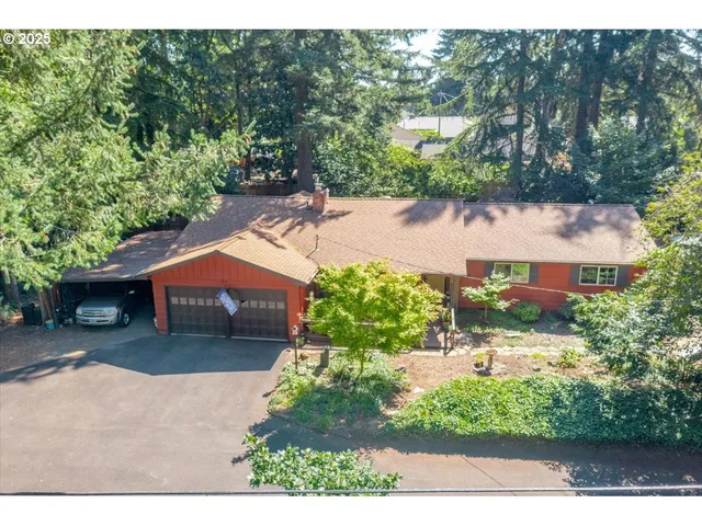 a view of a house with a yard and potted plants