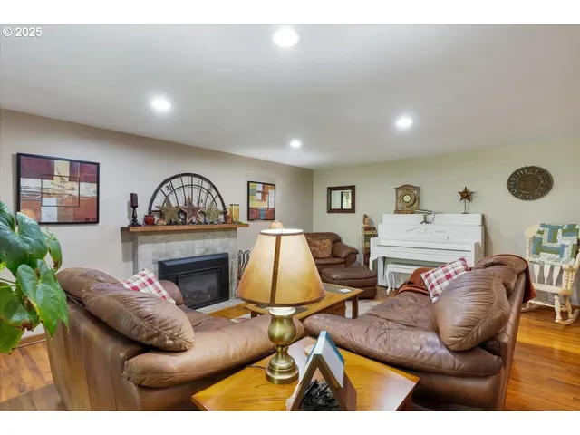 a living room with furniture a fireplace and a window