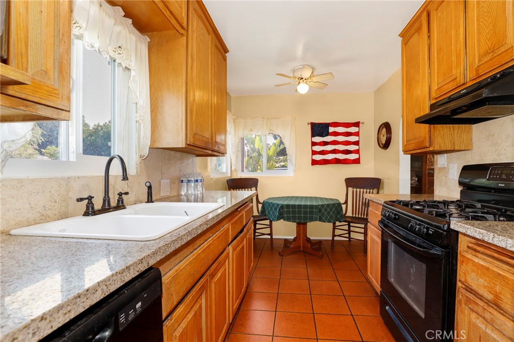 576 East Columbia Avenue Pomona, CA 91767 - Photo 11 of 27 a kitchen with stainless steel appliances granite countertop a sink and a stove