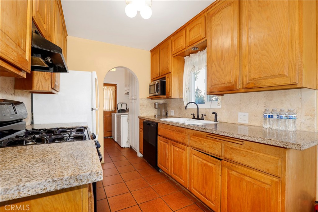 576 East Columbia Avenue Pomona, CA 91767 - Photo 12 of 27 a kitchen with stainless steel appliances granite countertop a sink stove and cabinets
