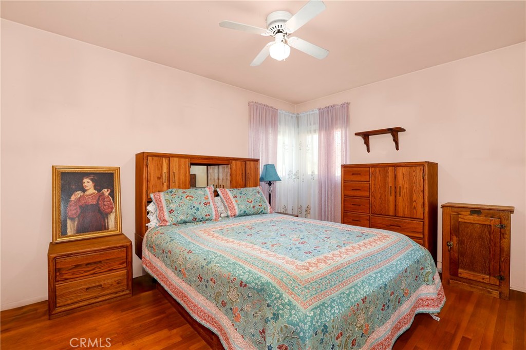 576 East Columbia Avenue Pomona, CA 91767 - Photo 15 of 27 a bedroom with a bed and wooden floor
