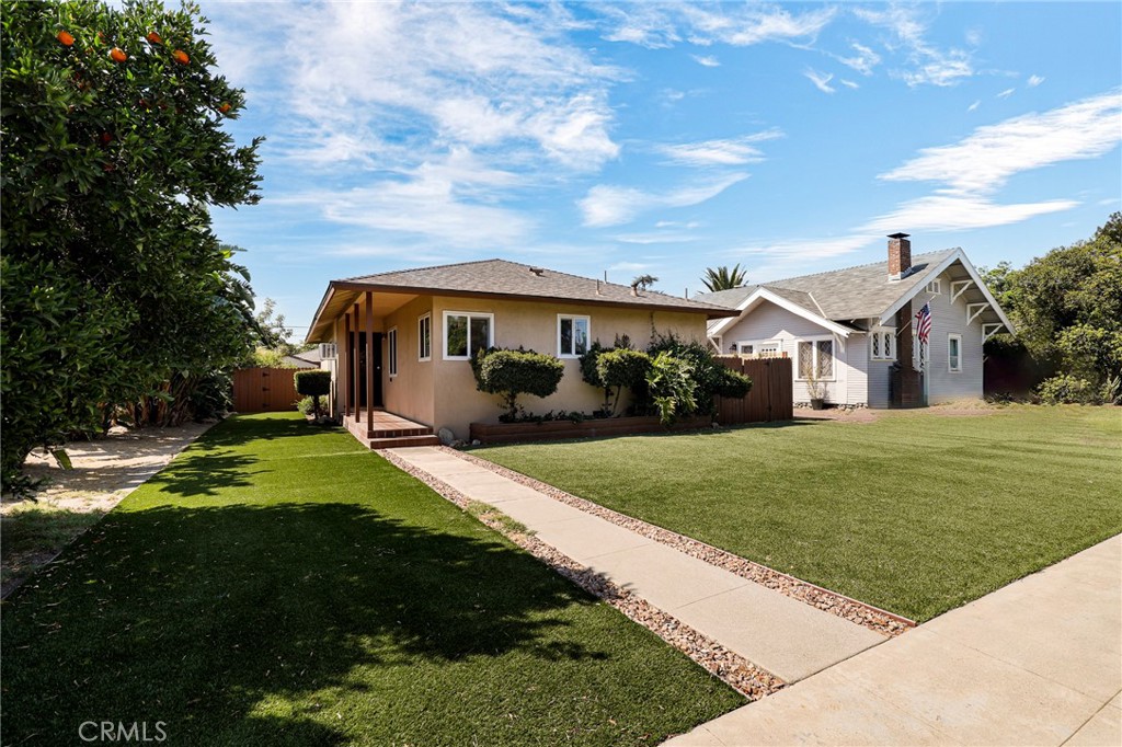 576 East Columbia Avenue Pomona, CA 91767 - Photo 2 of 27 a front view of a house with a yard