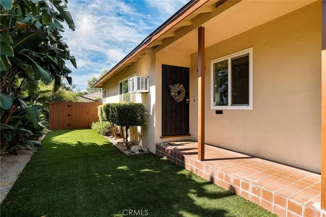 a backyard of a house with garden and plants
