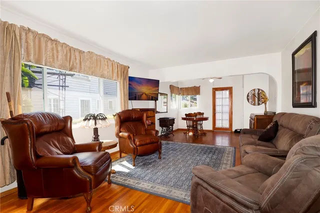 a living room with furniture fireplace and a large window