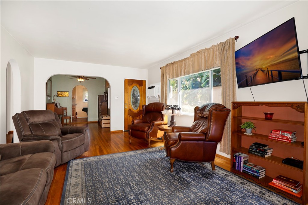 576 East Columbia Avenue Pomona, CA 91767 - Photo 5 of 27 a living room with furniture a flat screen tv and a floor to ceiling window