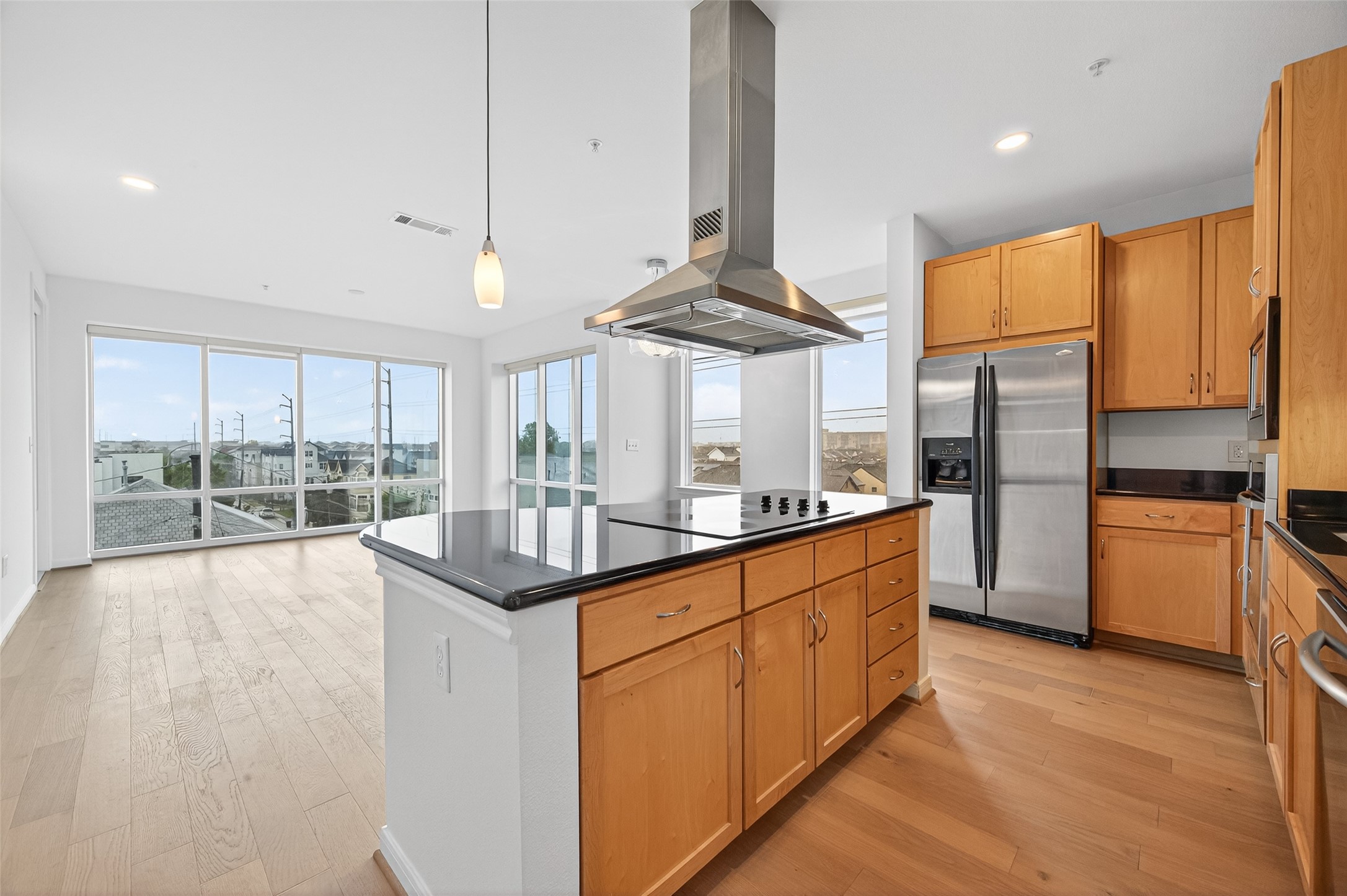a kitchen with stainless steel appliances granite countertop a stove a sink and a refrigerator