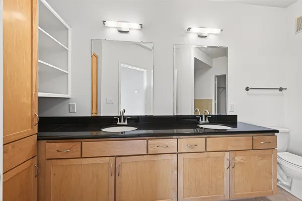 a bathroom with a granite countertop sink and a mirror