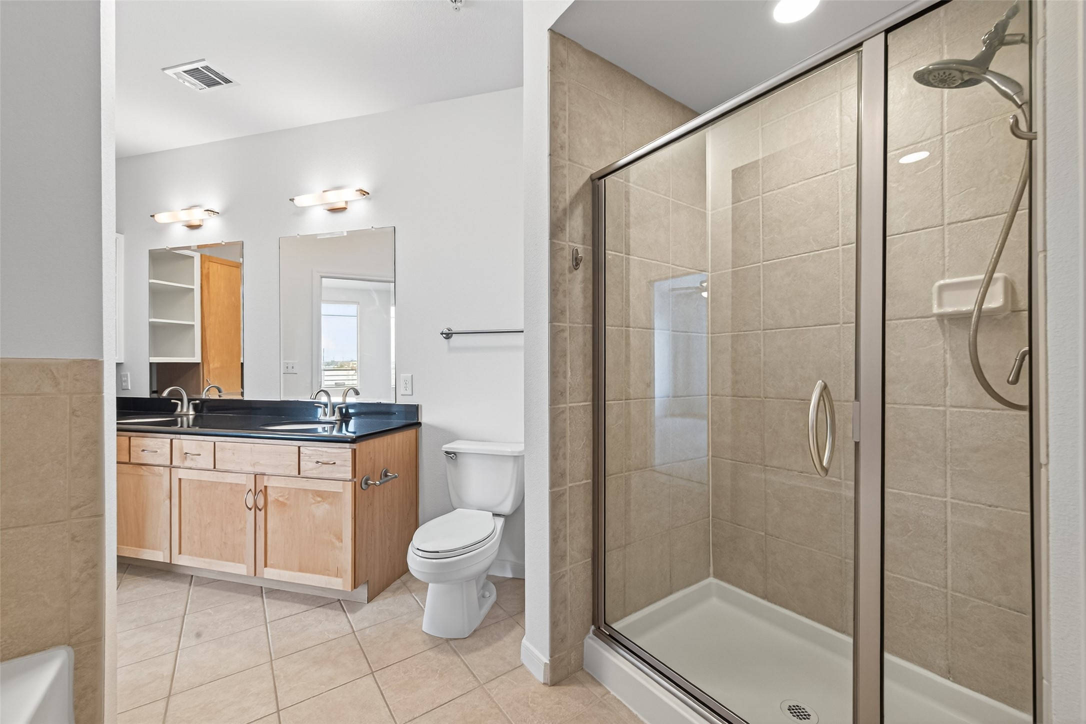 505 Jackson Hill Street, Unit 404 Houston, TX 77007 - Photo 13 of 24 a bathroom with a granite countertop sink a toilet and shower