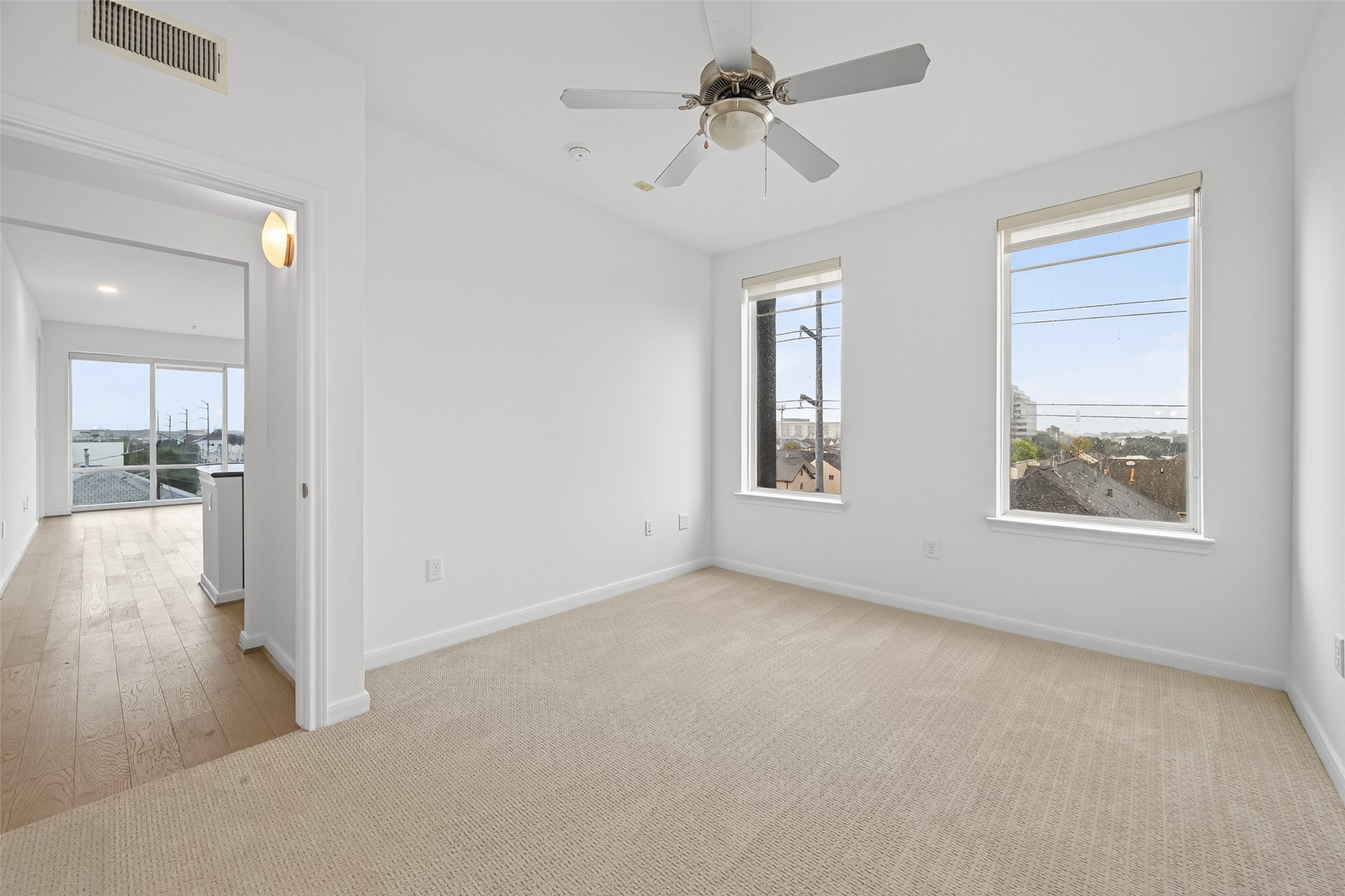 505 Jackson Hill Street, Unit 404 Houston, TX 77007 - Photo 16 of 24 a view of a big room with windows and chandelier fan
