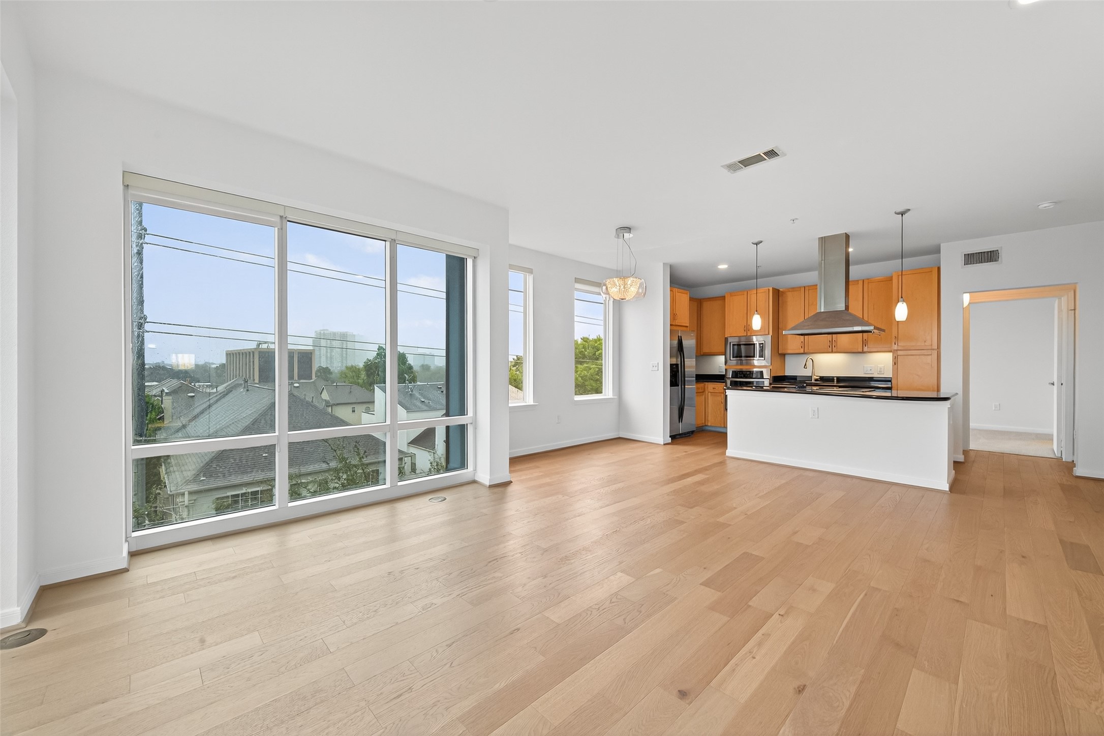 505 Jackson Hill Street, Unit 404 Houston, TX 77007 - Photo 3 of 24 a view of a kitchen with refrigerator a sink and a large window