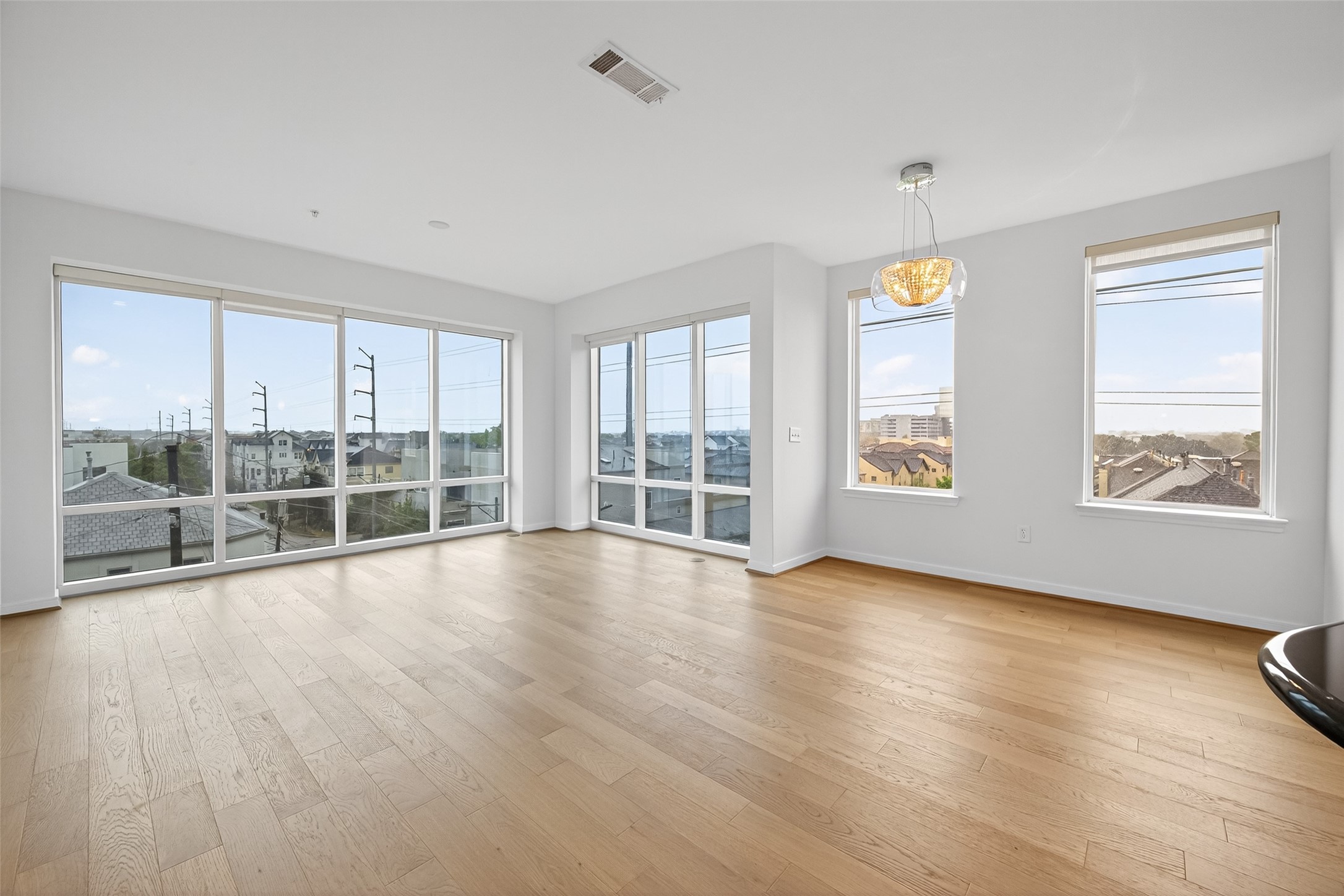 505 Jackson Hill Street, Unit 404 Houston, TX 77007 - Photo 7 of 24 a view of an empty room with wooden floor and a window