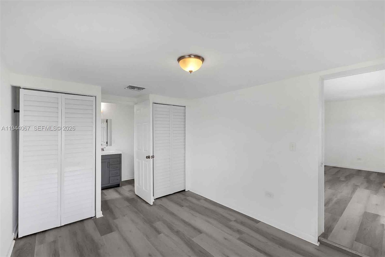 15351 Southwest 296th Street Homestead, FL 33033 - Photo 17 of 27 a view of empty room with wooden floor