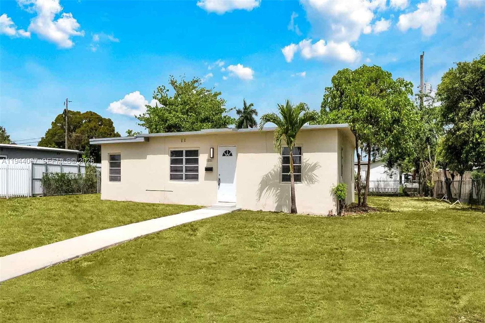 15351 Southwest 296th Street Homestead, FL 33033 - Photo 2 of 27 a house view with a garden space
