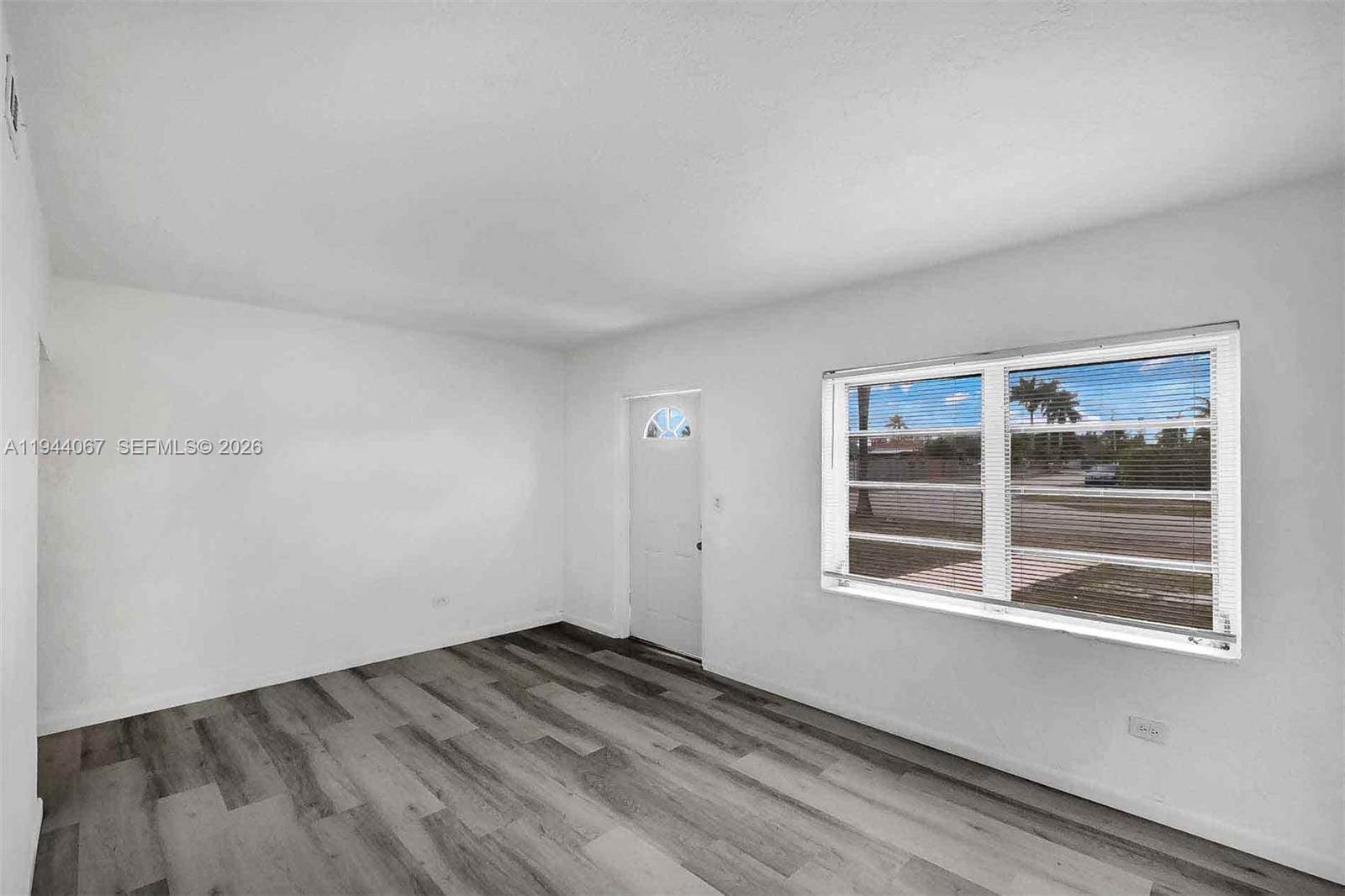 15351 Southwest 296th Street Homestead, FL 33033 - Photo 4 of 27 a view of empty room with wooden floor and fan