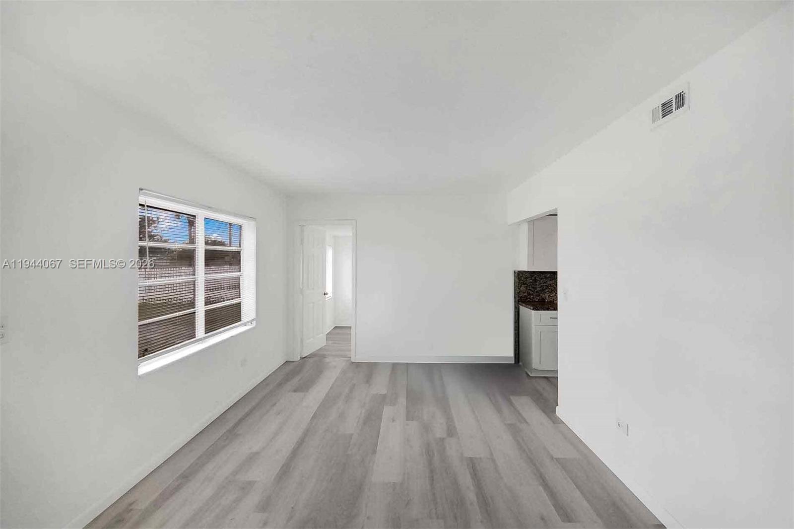 15351 Southwest 296th Street Homestead, FL 33033 - Photo 5 of 27 a view of empty room with wooden floor and fan
