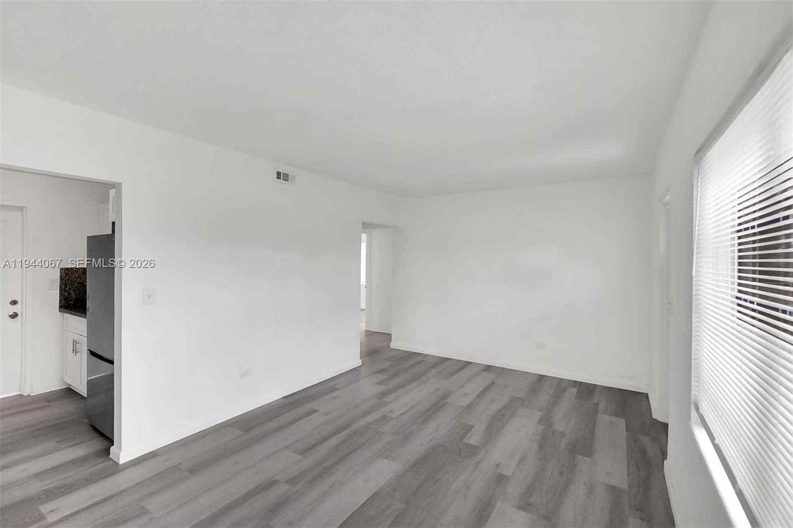 15351 Southwest 296th Street Homestead, FL 33033 - Photo 7 of 27 an empty room with wooden floor and windows